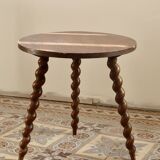 Vintage circular side table in wood with turned legs.