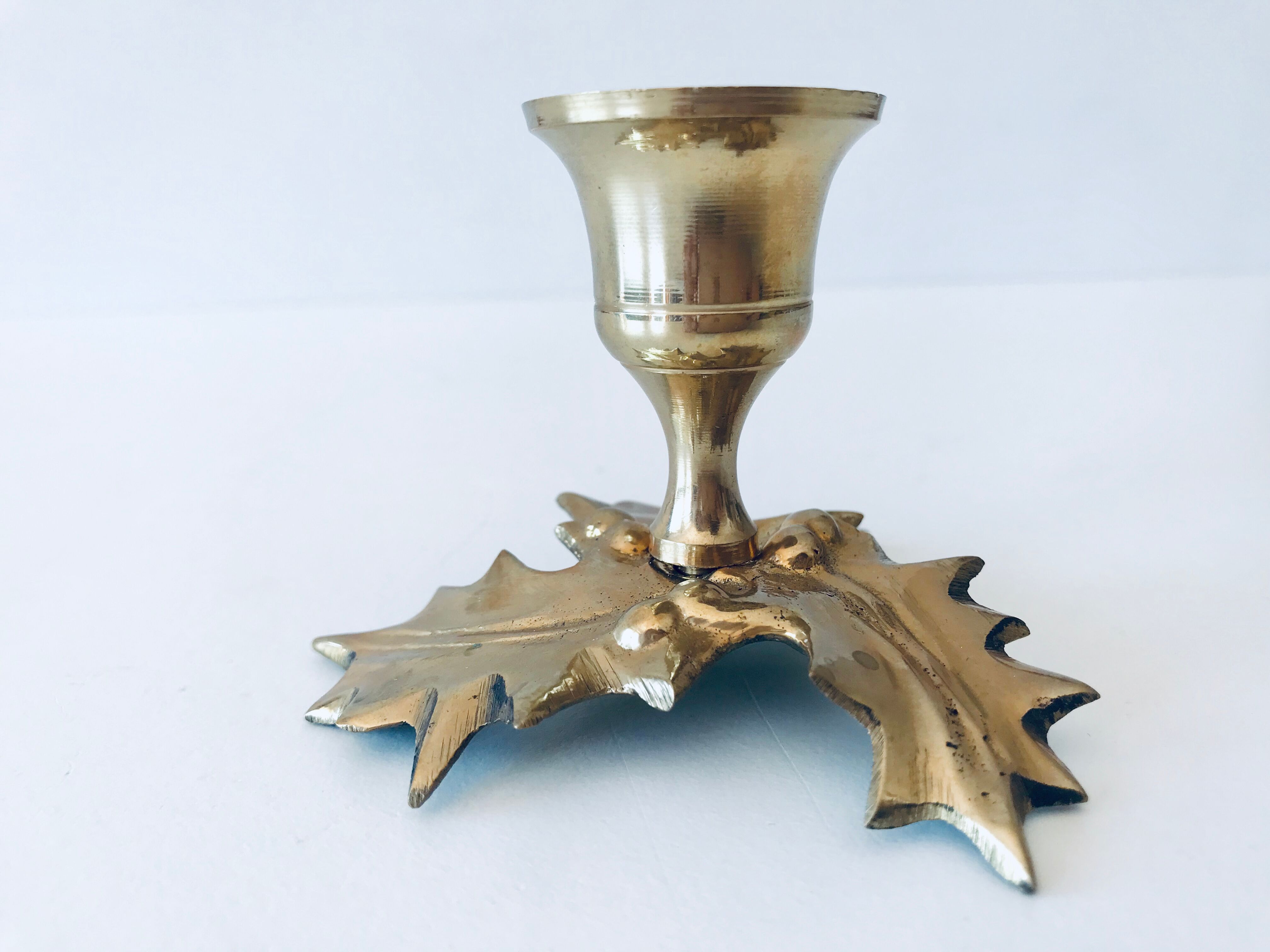 Candlestick in brass holly design