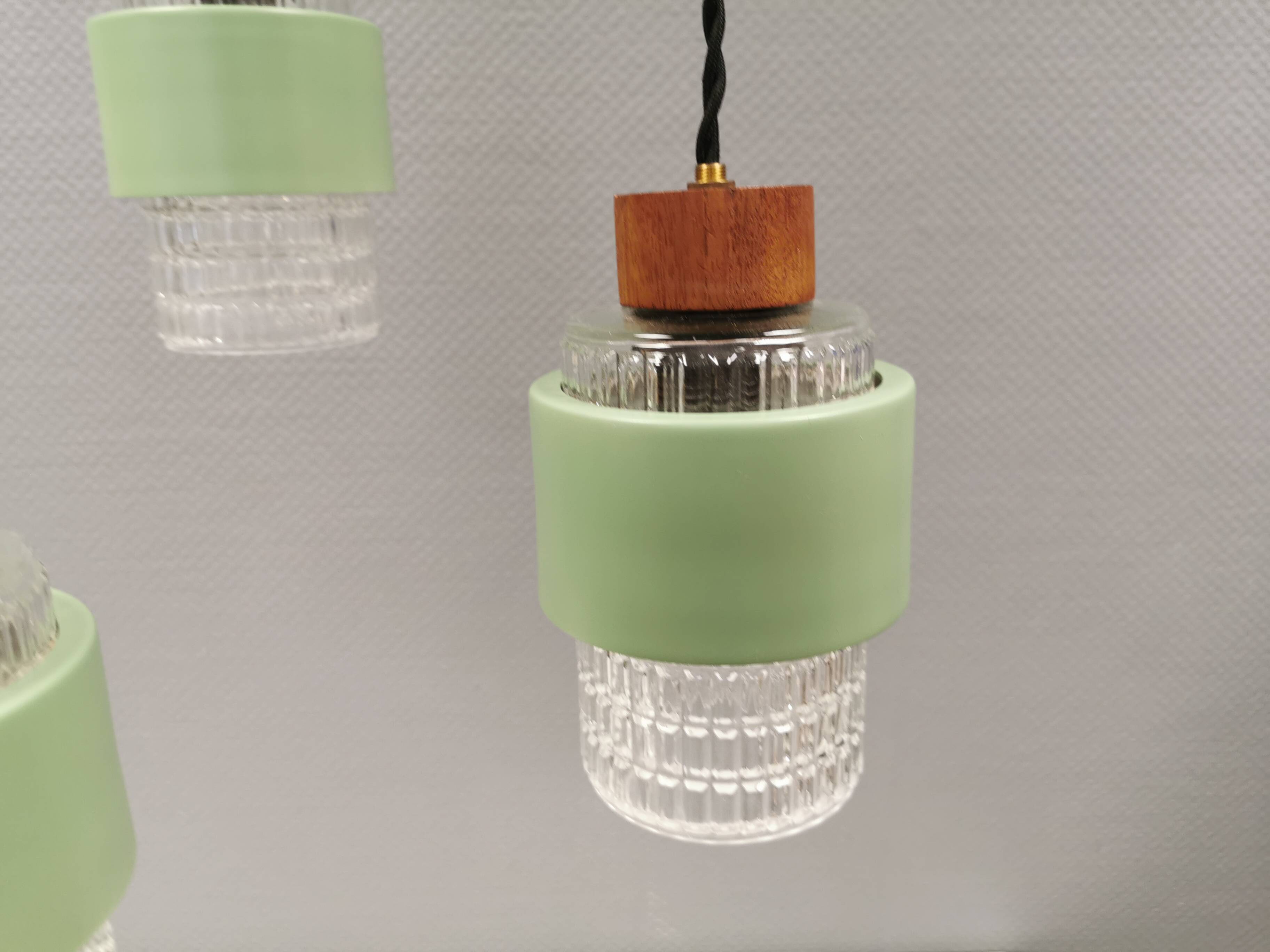 Three-part pendant in crystal glass, teak wood, and thin dusty green metal