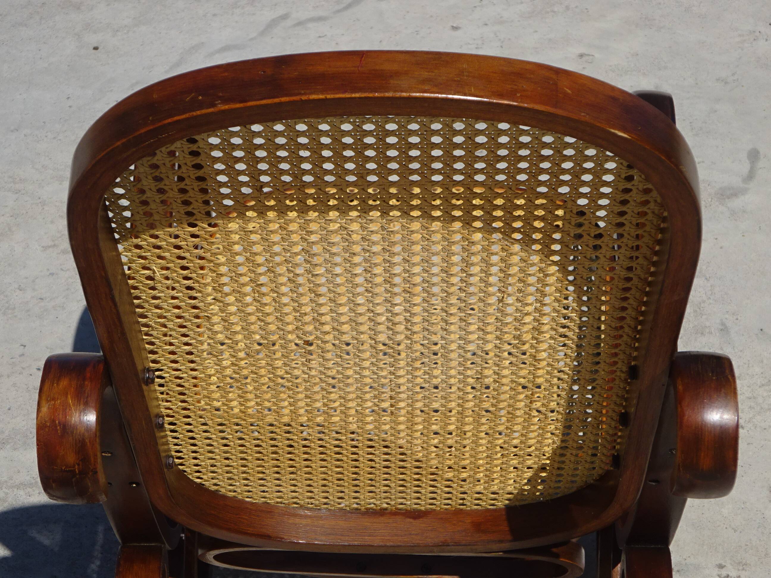 Vintage wooden rocking chair with caning