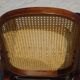 Vintage wooden rocking chair with caning