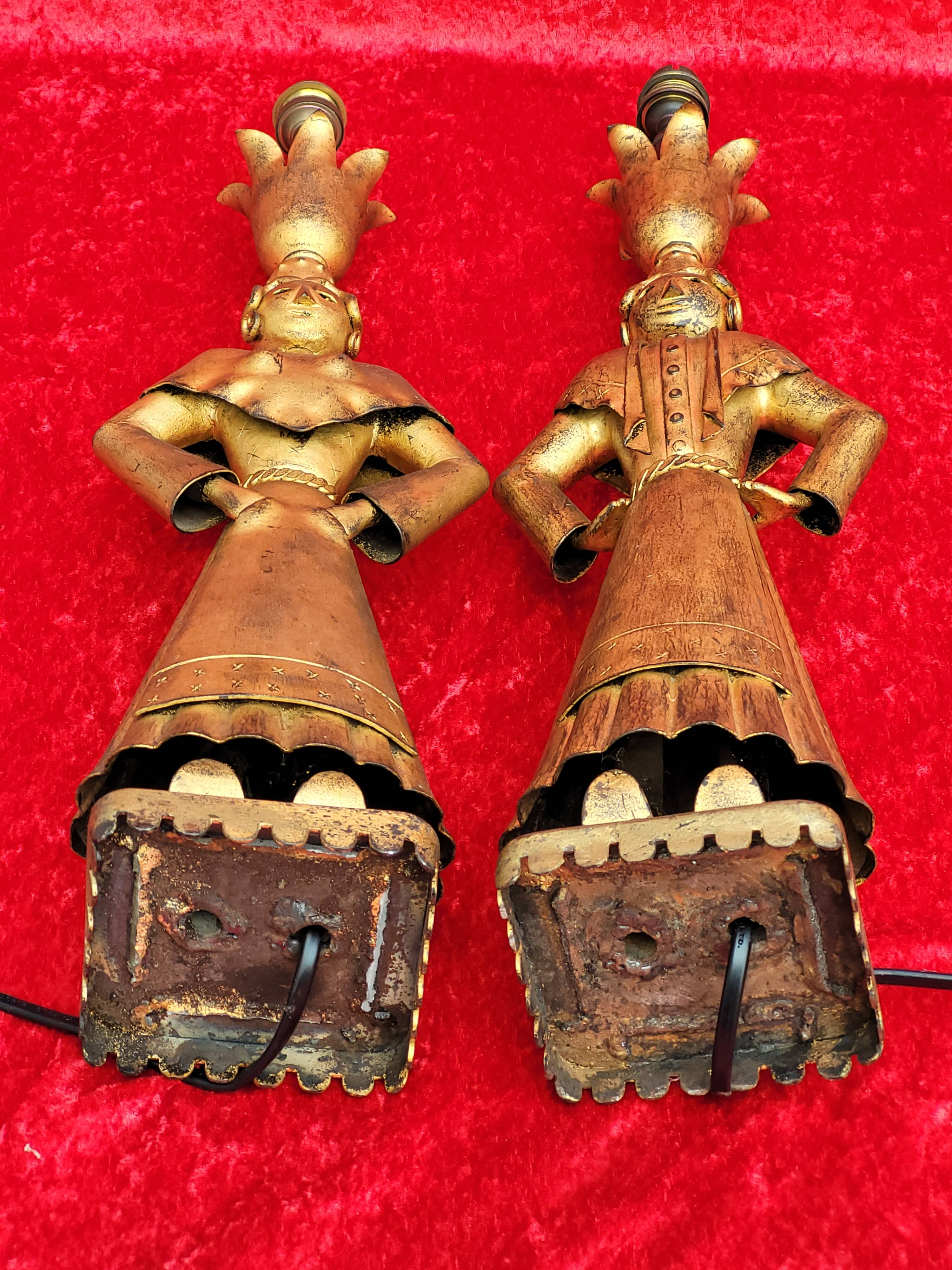 Pair of gilded beaten iron sculpture lamps attributed to Gilbert Poillerat