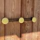 Vintage yellow metal wall coat rack