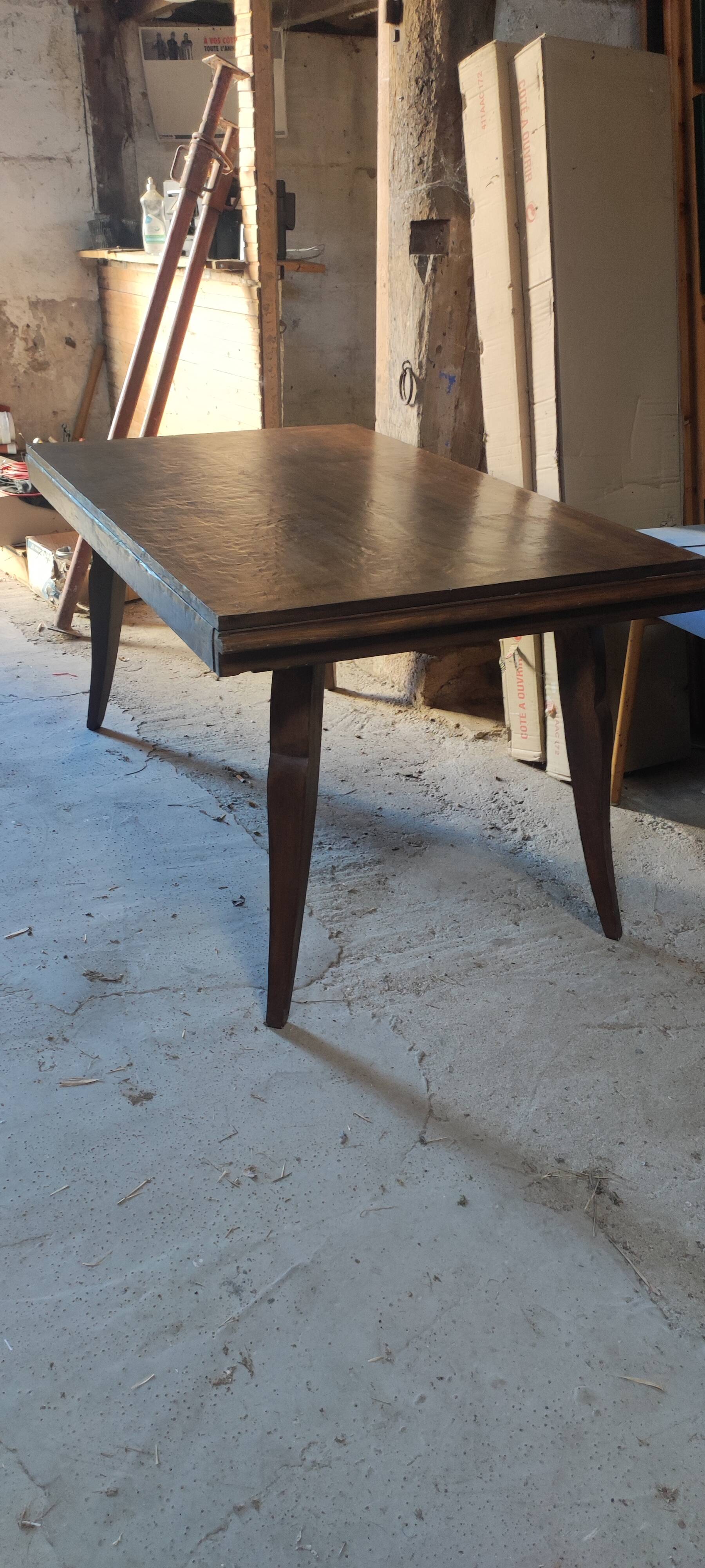Solid oak dining table with integrated extensions.