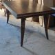 Solid oak dining table with integrated extensions.