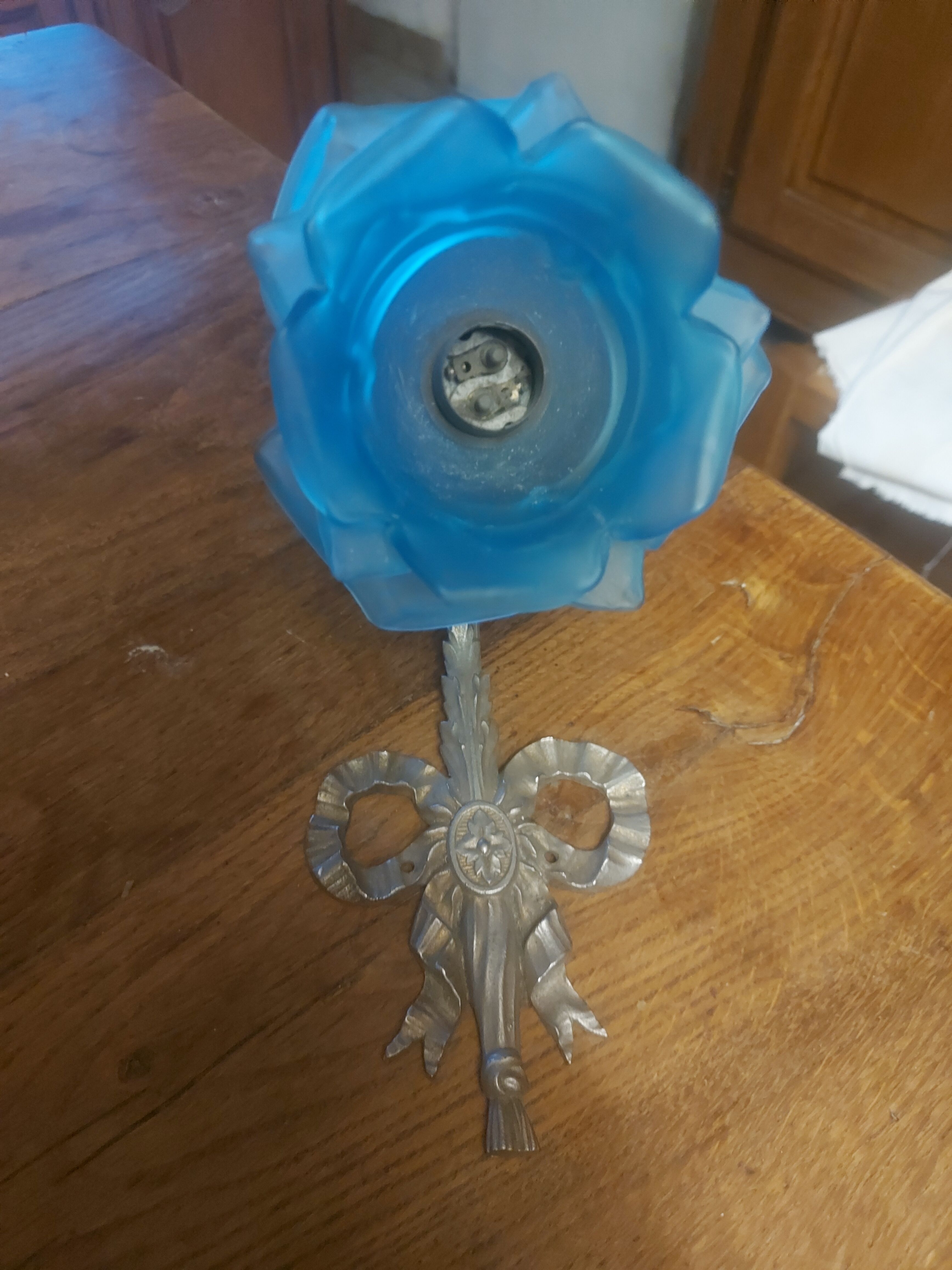 Art Deco style wall light in frosted blue glass with silver metal support.
