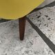 Yellow cocktail chair in solid beech, 1960s, with fluted backrest and tapered legs.