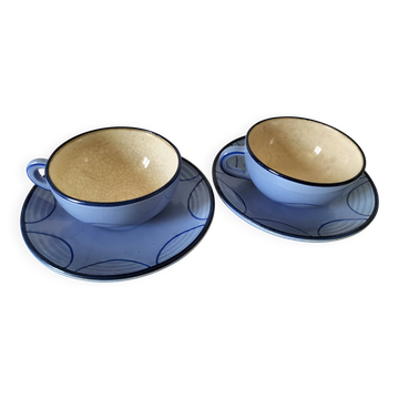 A pair of glazed ceramic cups and saucers from the 60s-70s.