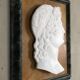 Profile of a young man in the style of antique marble.