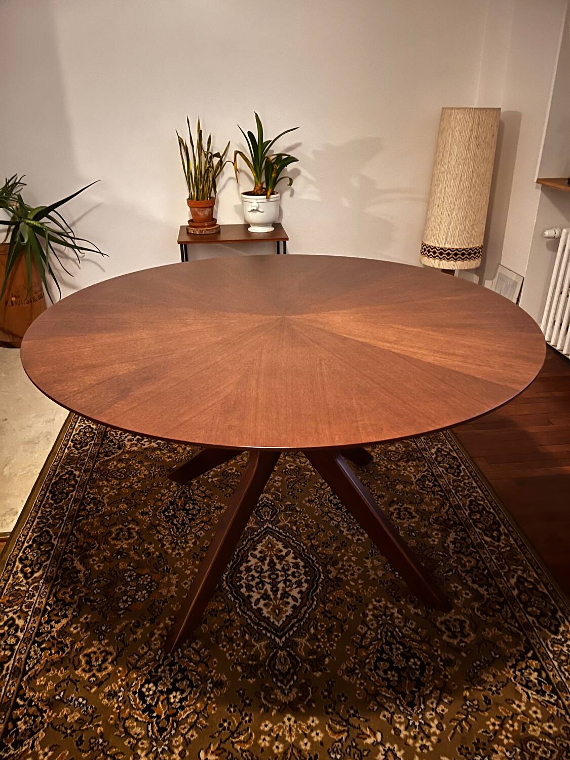 Round table made of solid wood with a walnut finish top.