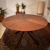 Round table made of solid wood with a walnut finish top.