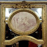 Very large mirror with mouldings, richly carved and gilded, in the Louis XVI style.