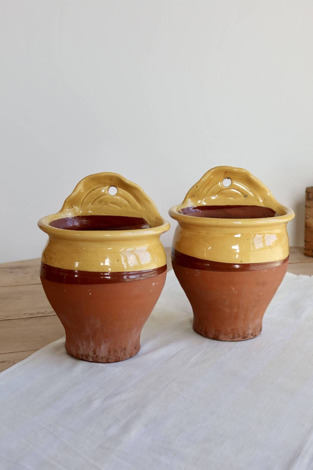 Pair of vintage wall planters in yellow glazed stoneware.