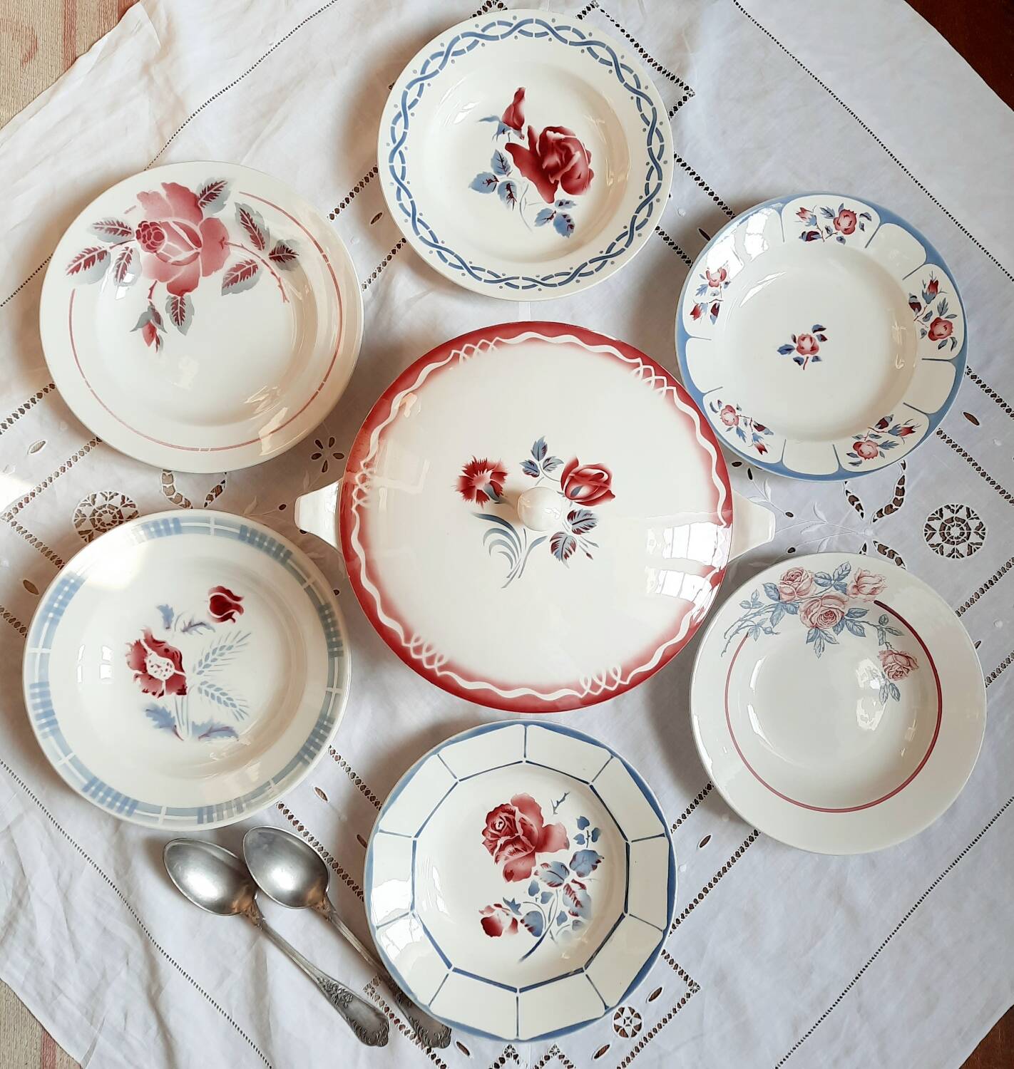 Mismatched old soup plates accompanied by a soup tureen