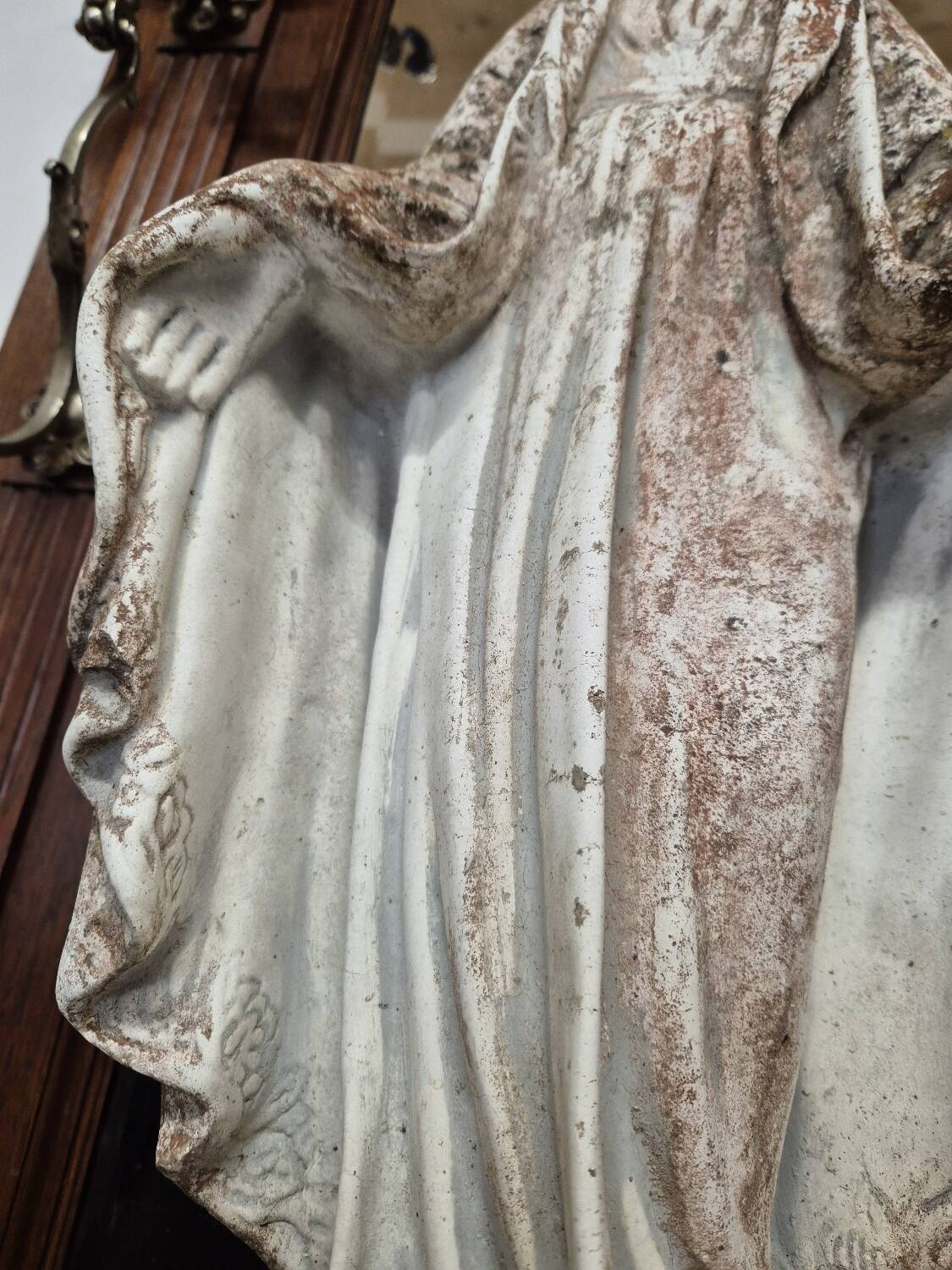 Garden statue of the Virgin Mary in old reconstituted stone