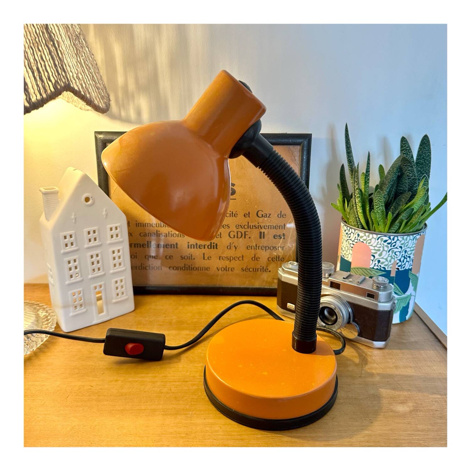 Orange articulated desk lamp