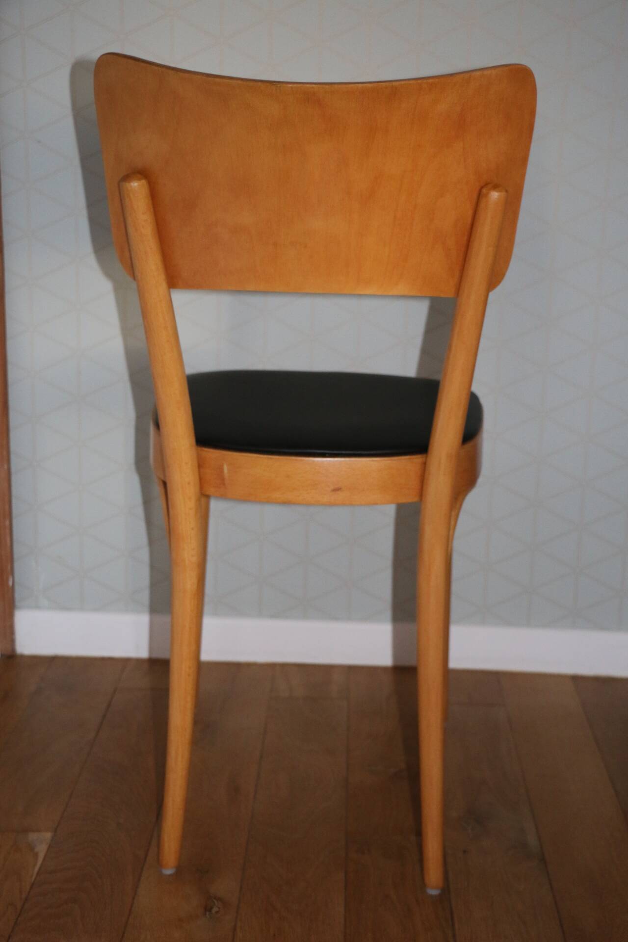 5 baumann chairs with large backs in black faux leather.