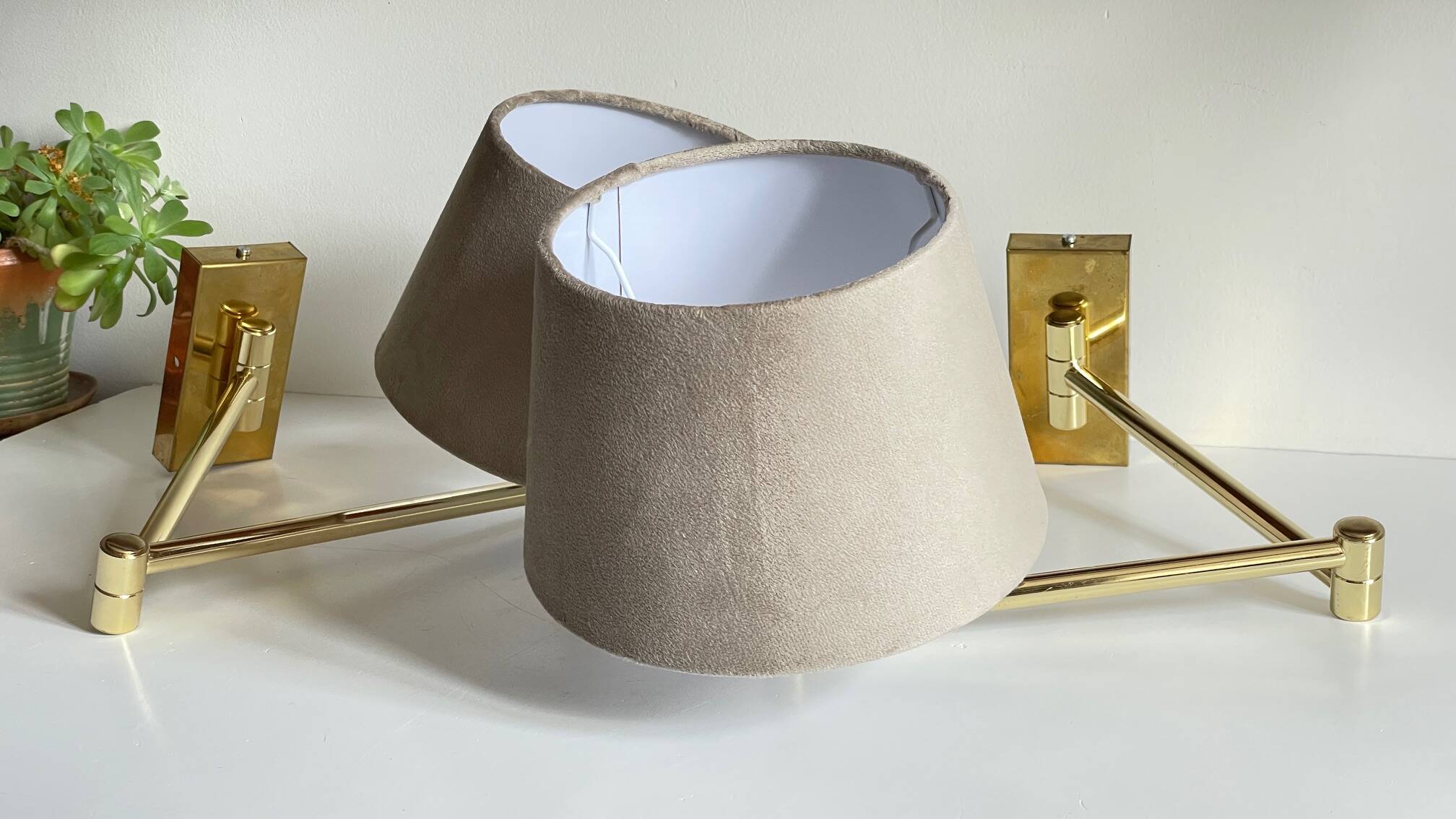 articulated brass and velvet wall light