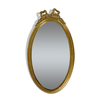 Golden oval mirror