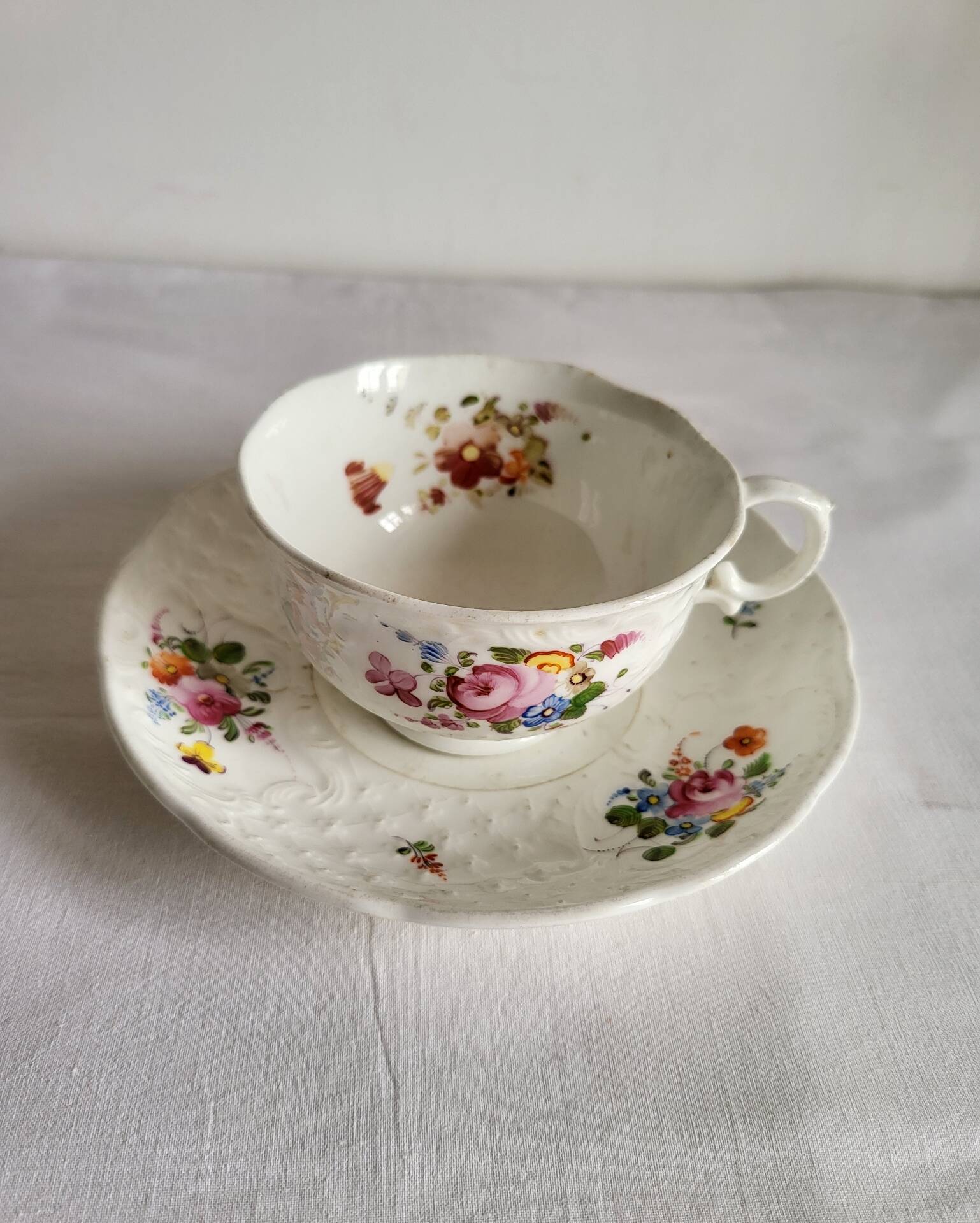 Antique Cup and Saucer in Porcelain with Hand-Painted Floral Decoration