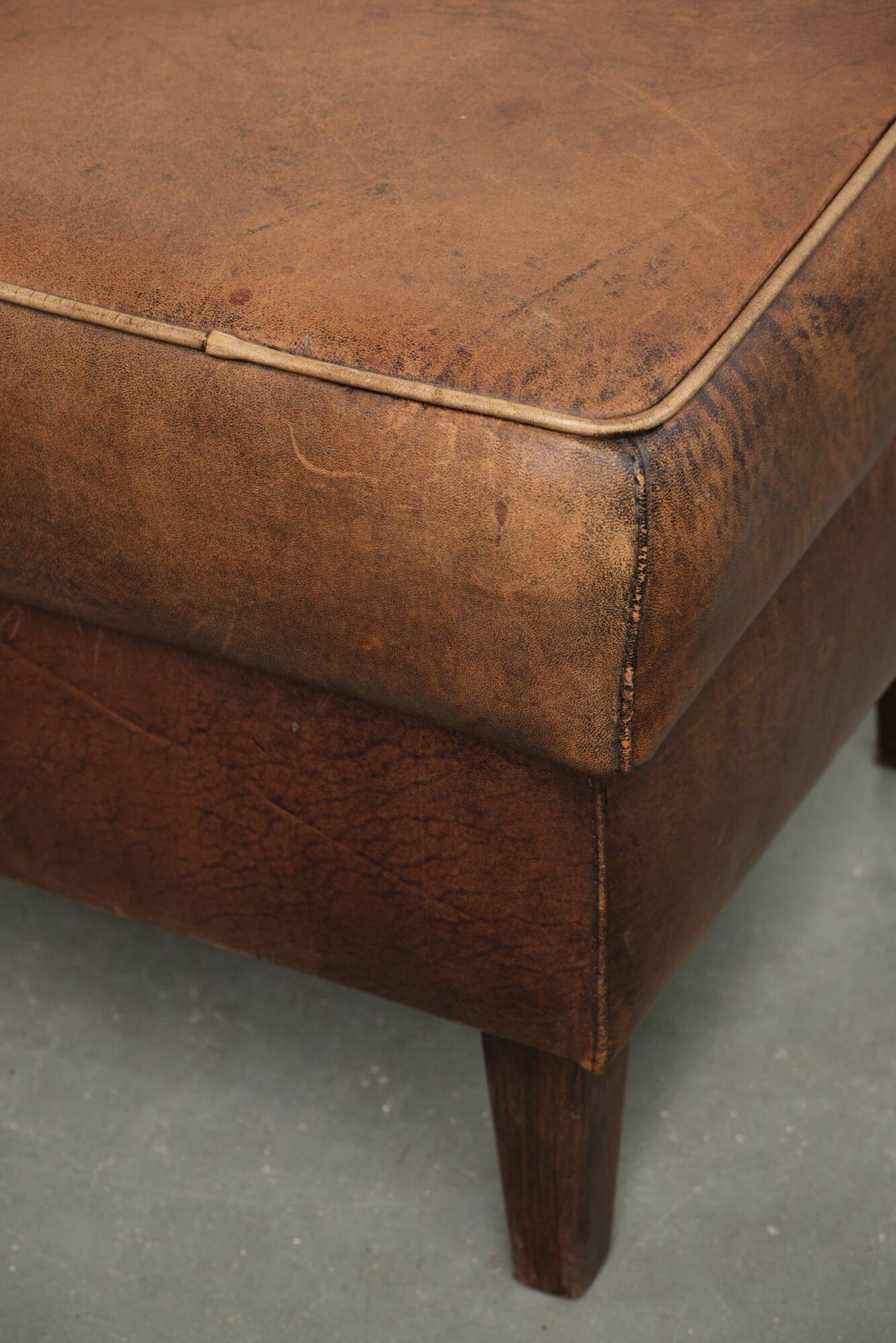 Sheepskin ottoman with a light brown colour scheme and a vintage look