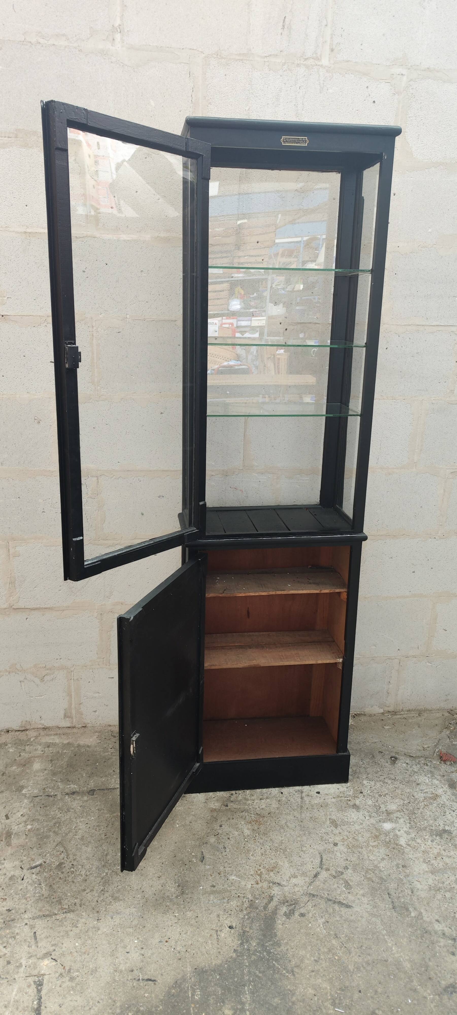 Old two-door shop showcase with black patina