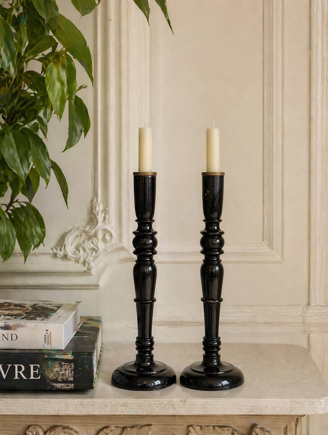 Pair of antique ebonised wooden candlesticks from the 19th century.
