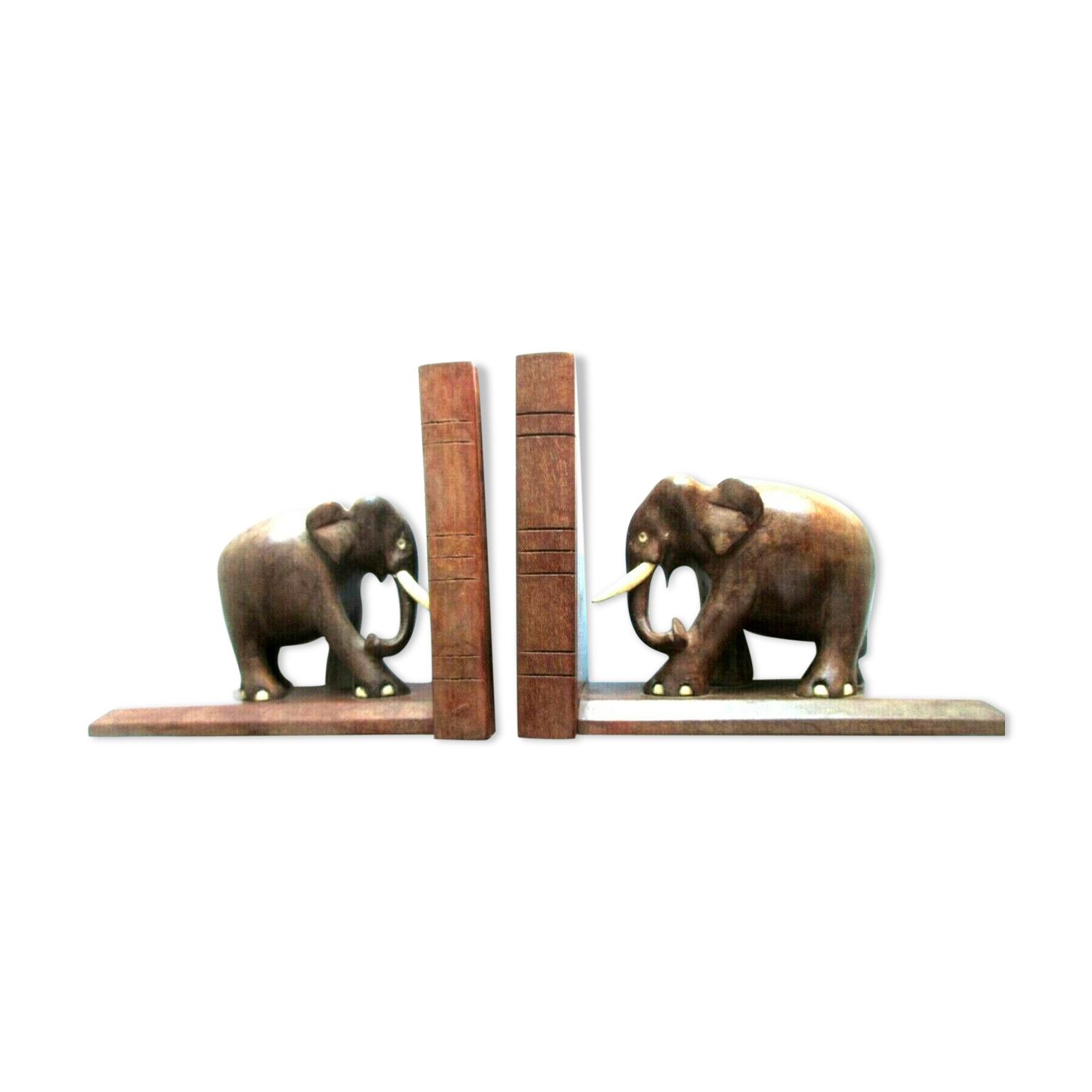 Art Deco bookends wooden elephants and bones on wooden terrace, book shape