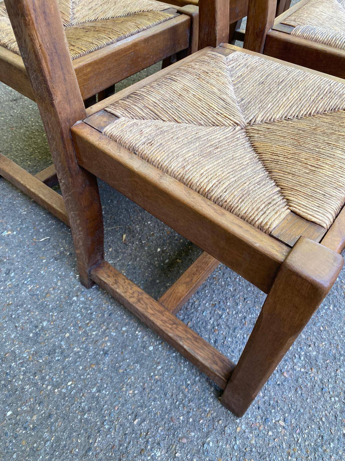 6 solid oak chairs with rush seats in a country style.