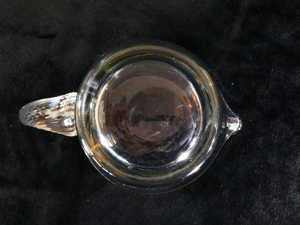 Pitcher Carafe has orangeade em blown glass