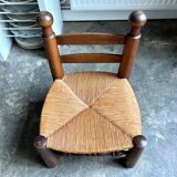 Brutalist low chair in dark wood and straw no. 1