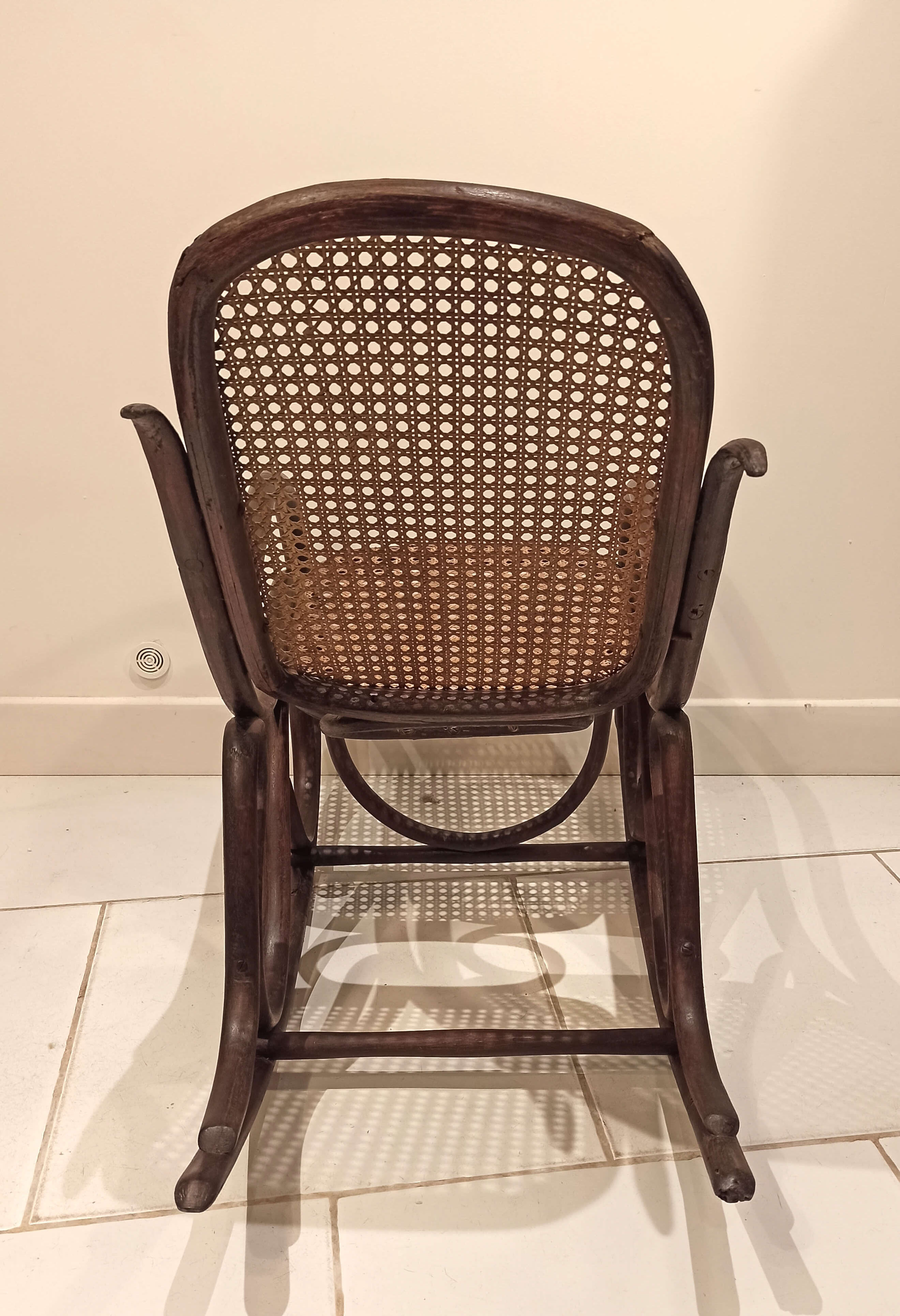 Vintage rocking chair for children in dark rattan and canework, rocking chair