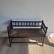 Turned wood bobbin bench with a straw seat.