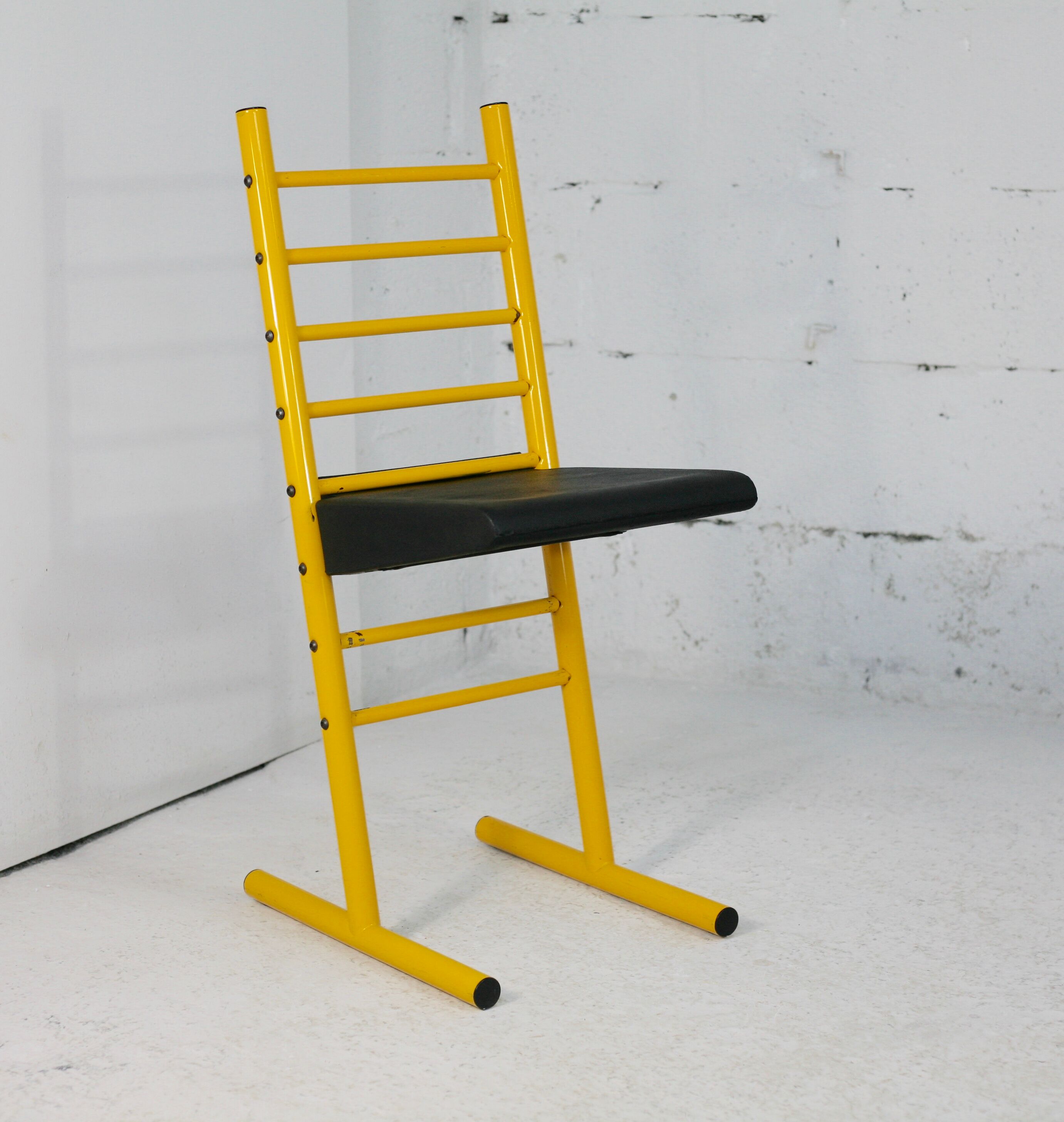 Adjustable seat chair. Circa 1980. Italy. Yellow lacquered steel.