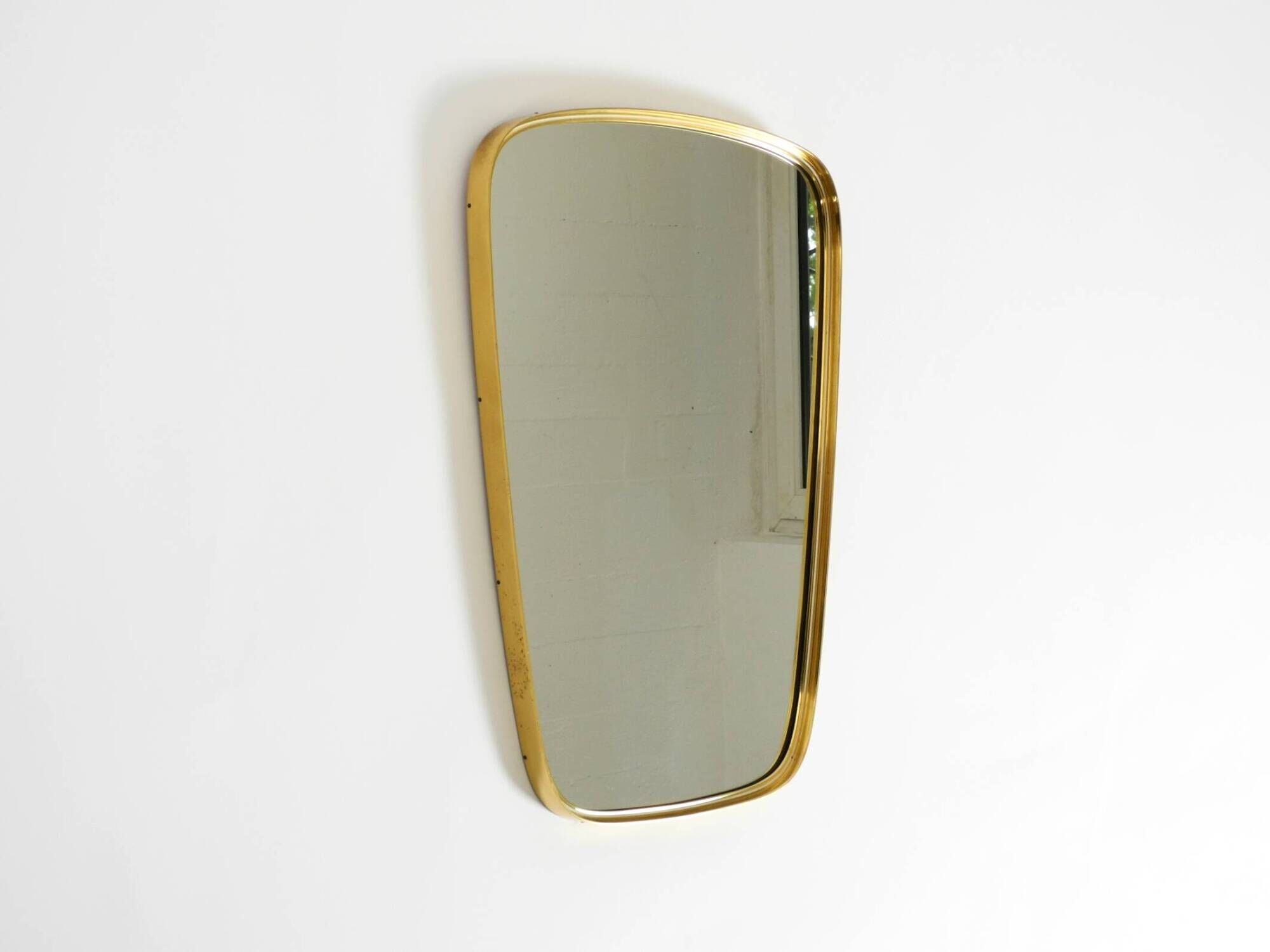 A pair of rare Mid Century "Münchener Zierspiegel" brass wall mirrors