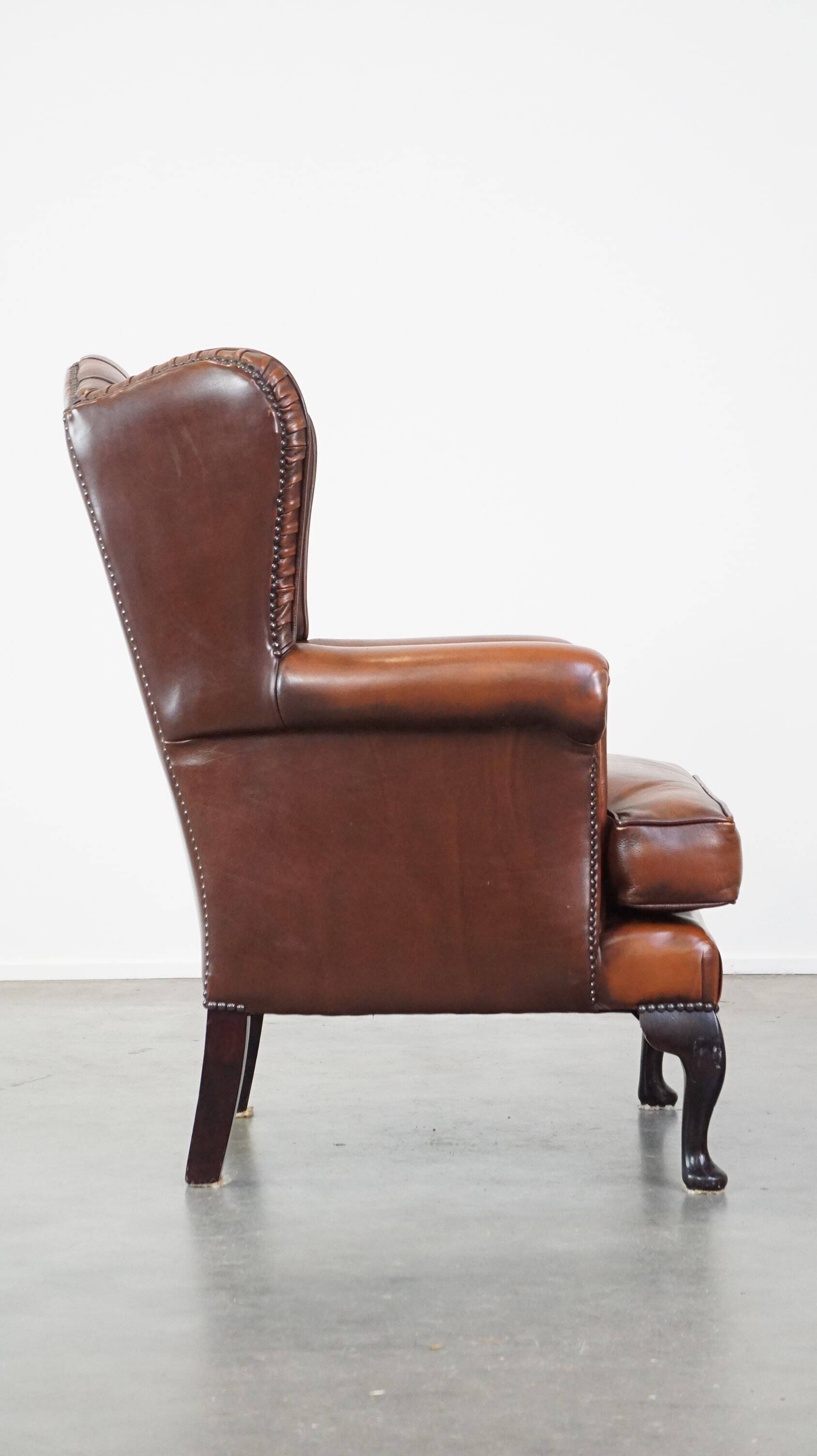 Brown leather wingback Chesterfield armchair