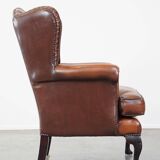 Very beautiful, stately, cowhide Chesterfield wing chair with elegant legs in a nice brown color