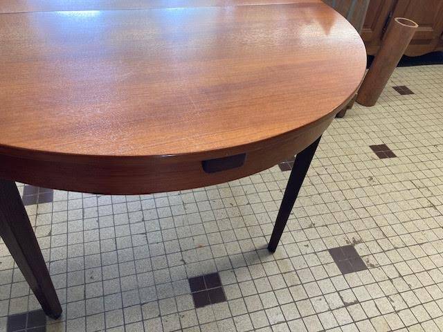 Round wooden table with integrated extensions