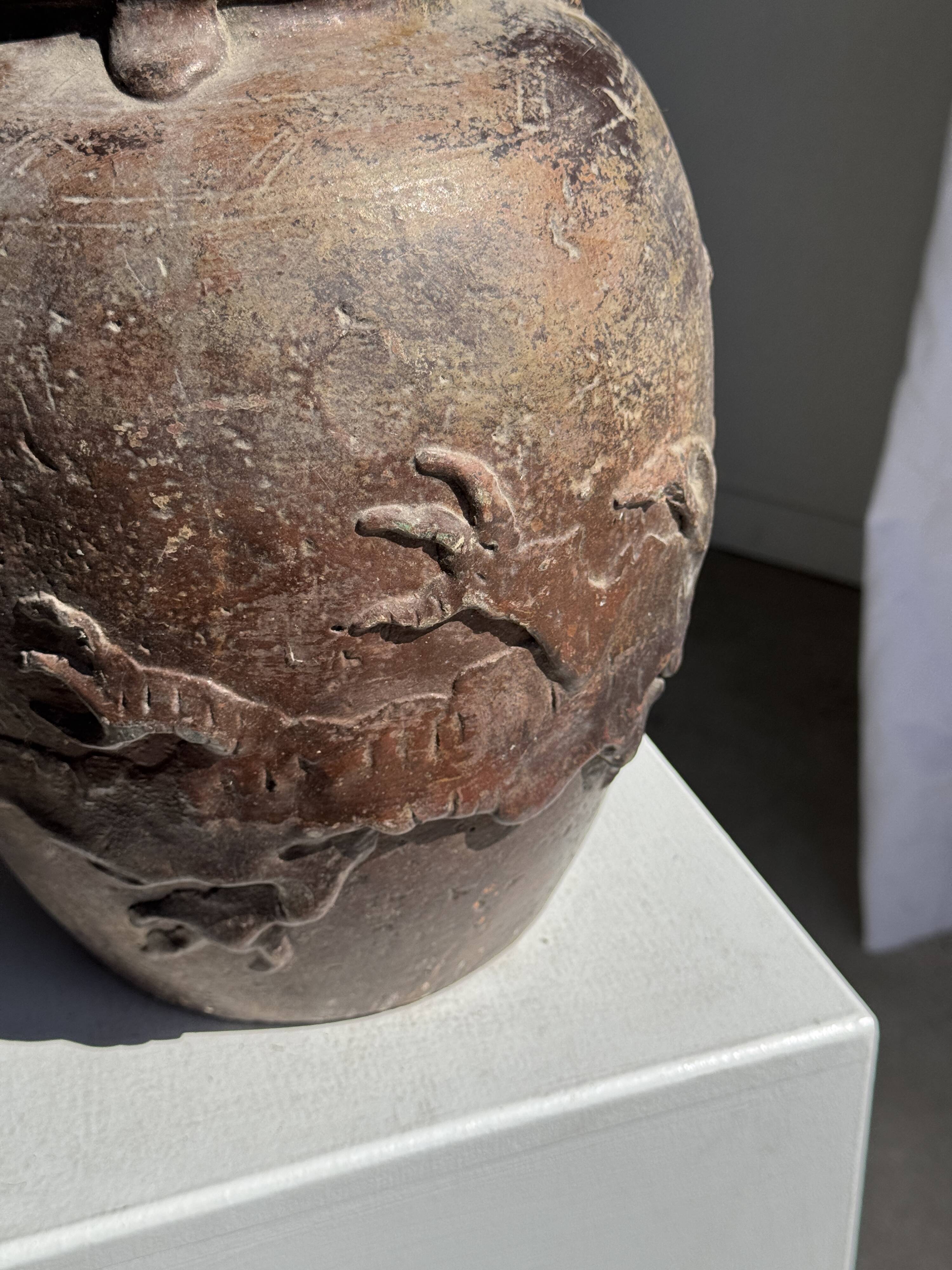 Large traditional Indonesian clay pot featuring a dragon.