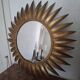 Large sun mirror in gilded metal. 1960
