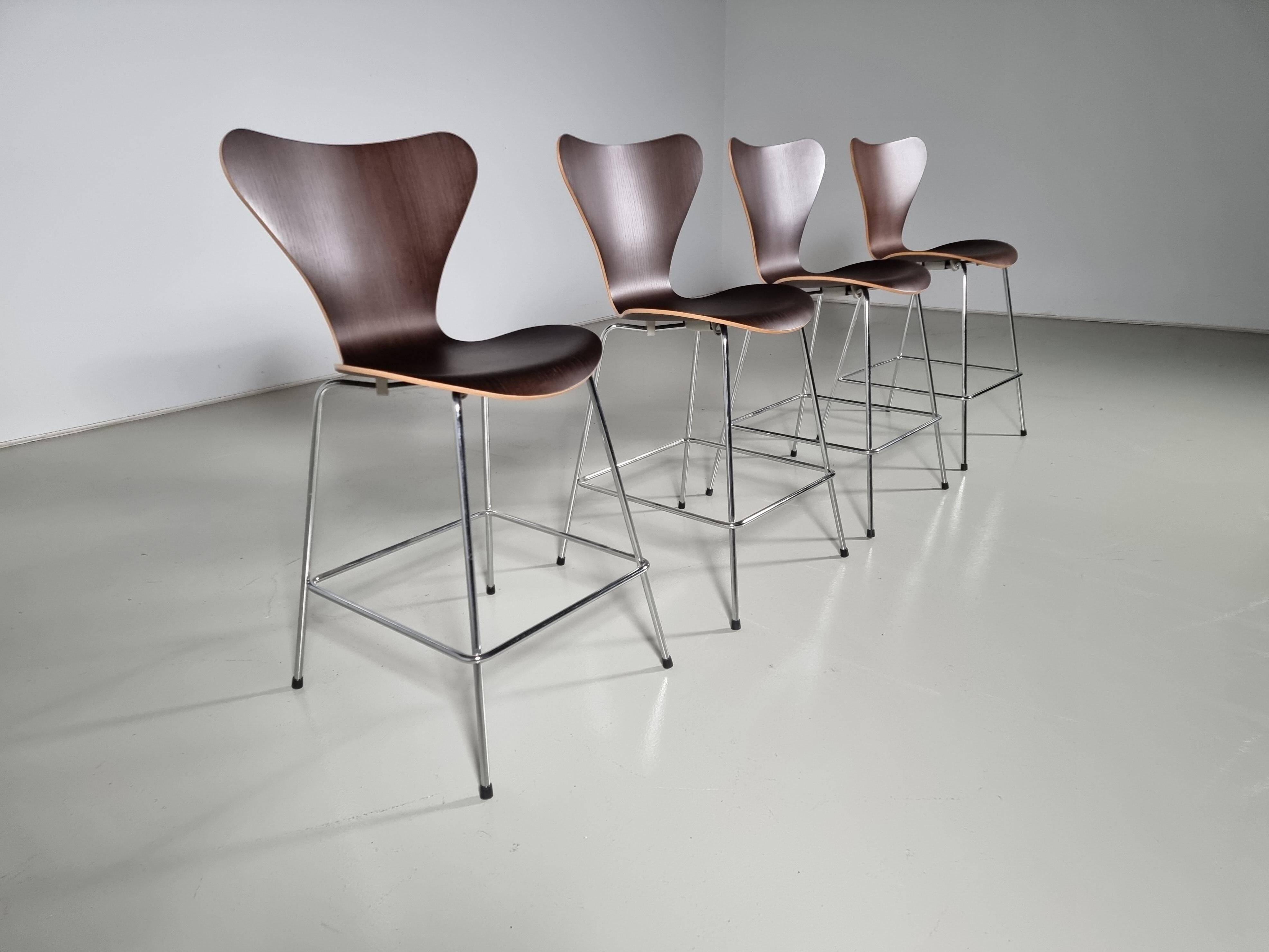 Set of 4 brown oak plywood bar stools by Fritz Hansen Series 7 by Arne Jacobsen.