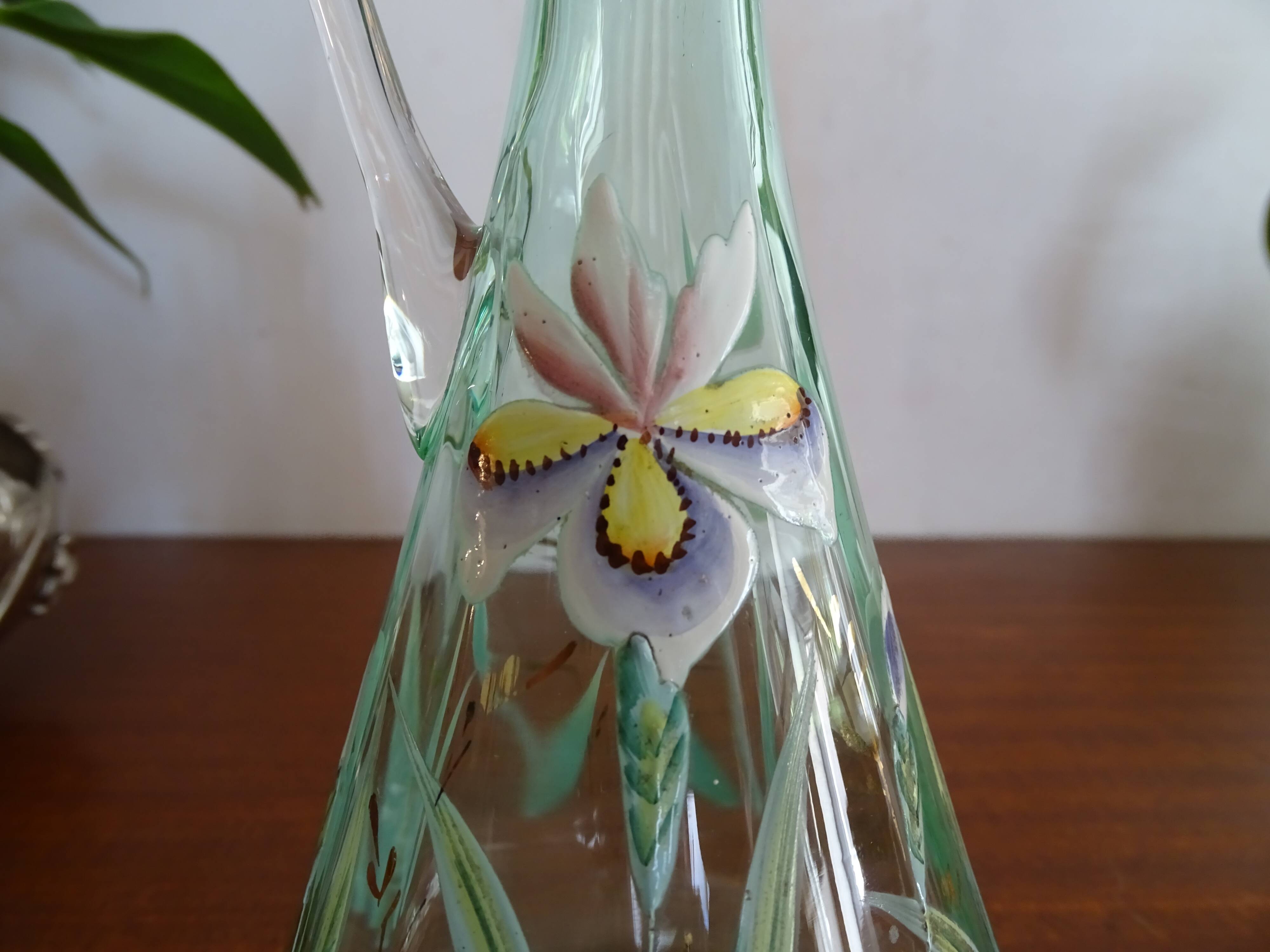Old carafe enamelled with glass flowers