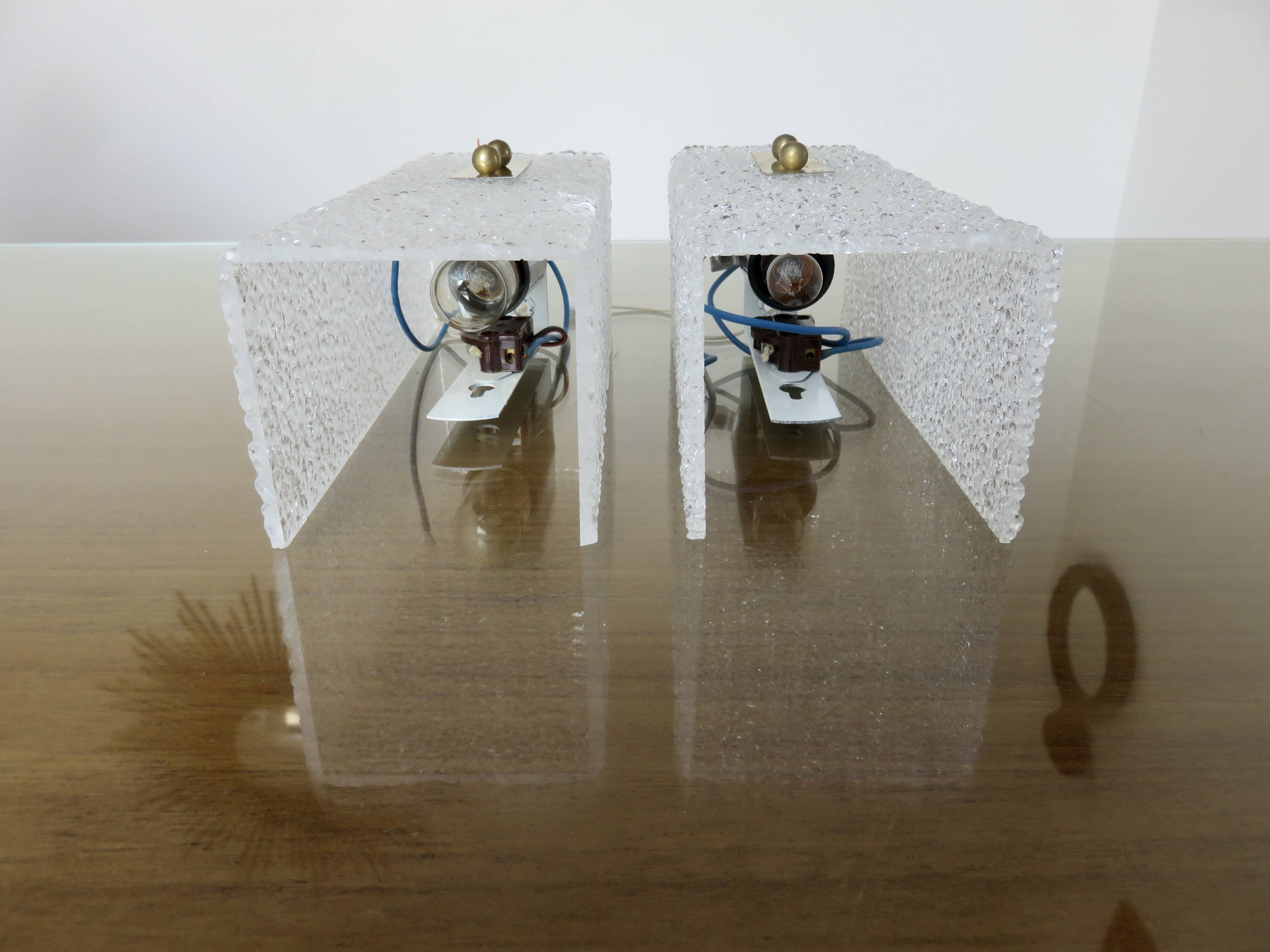 Pair of pull switch wall lights in perspex and gilded brass, France, circa 1960.