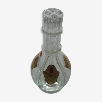 A liquor decanter has 4 compartments in glass