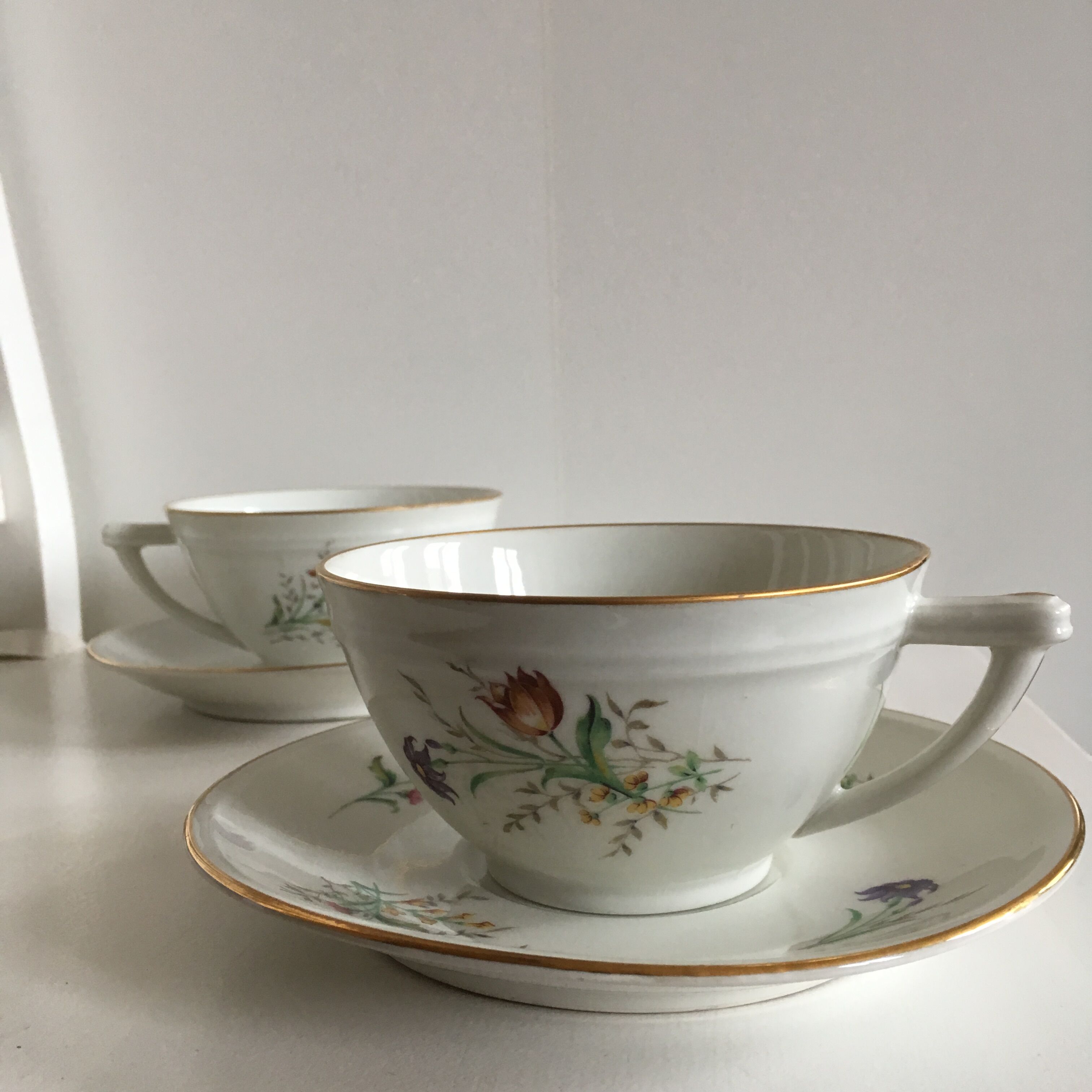 Duo of white Limoges porcelain cups with flowers