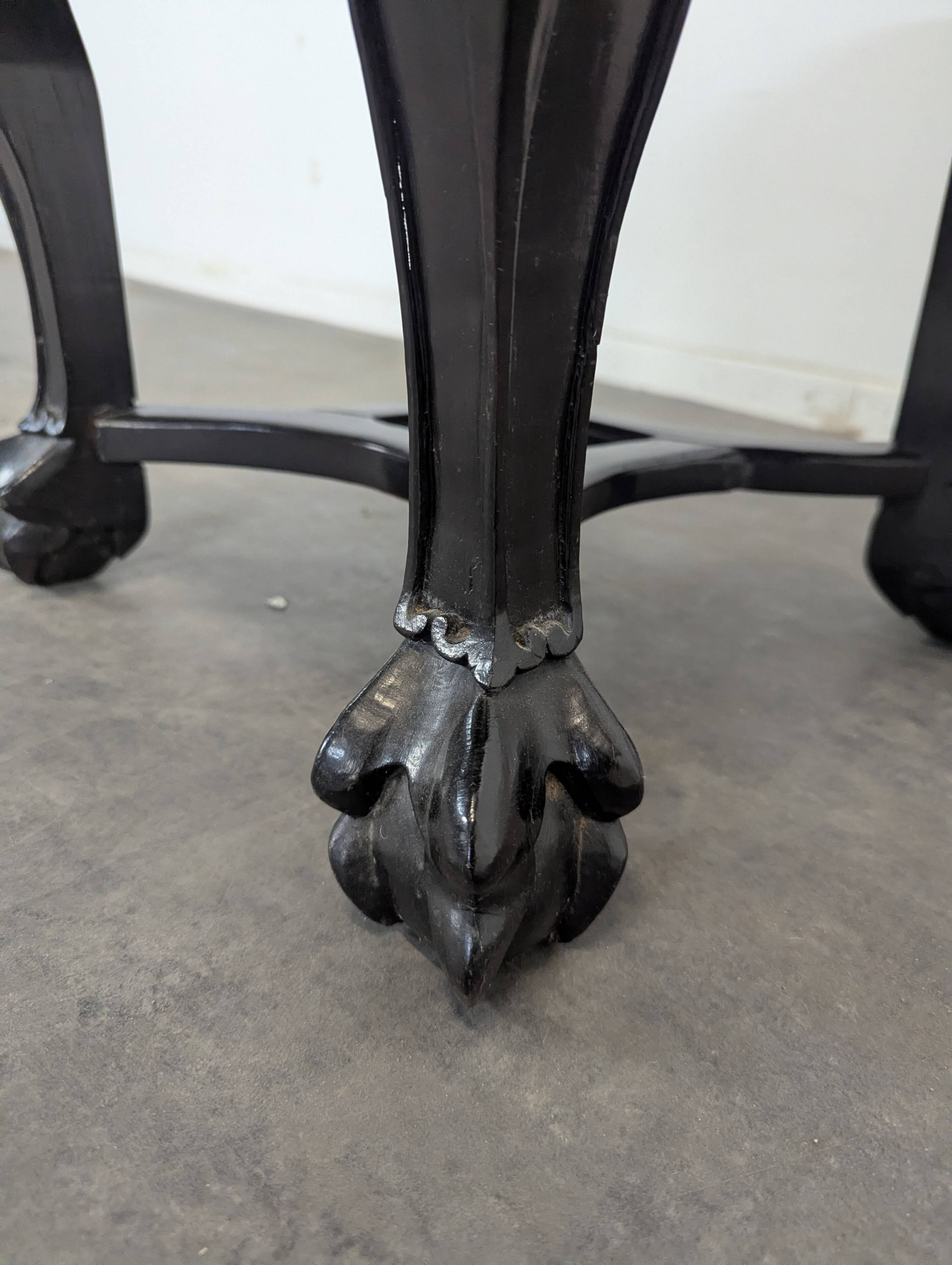 Side table with a wooden frame and marble top.