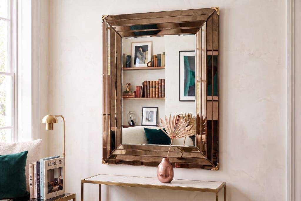 Vintage gold wall mirror with a smoked mirror border.