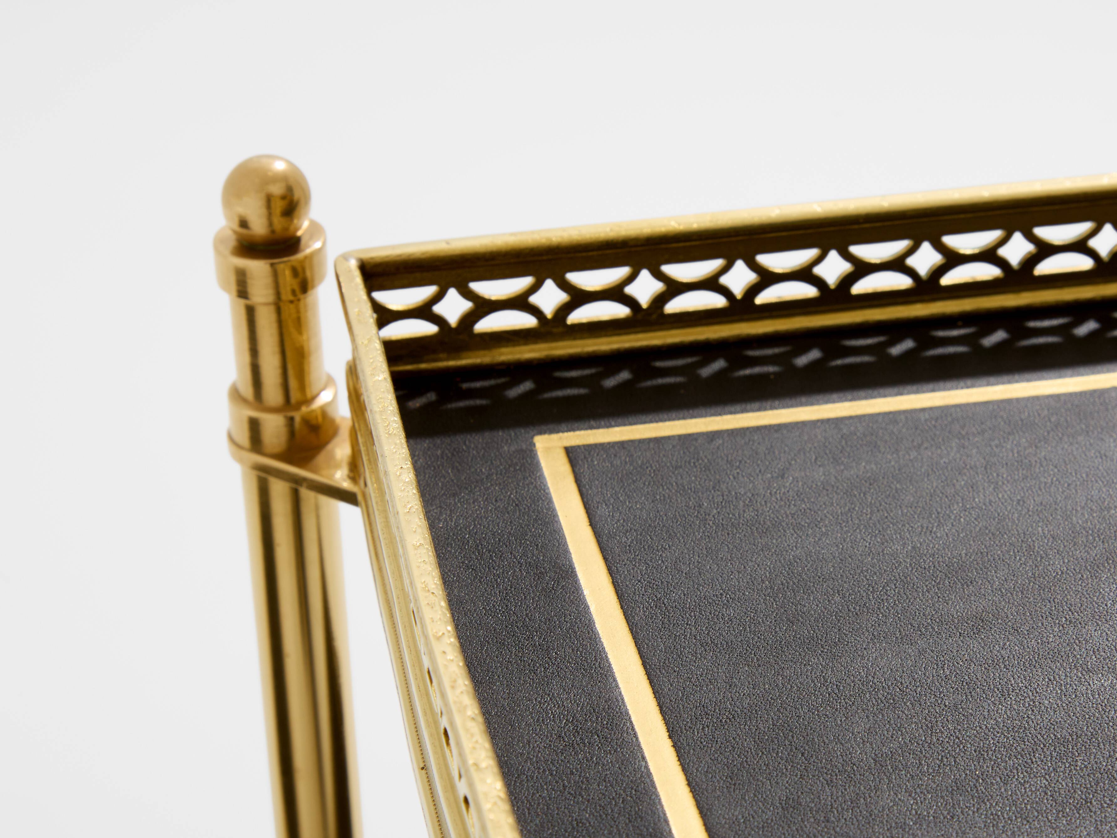 Pair of neoclassical side tables in brass and black leather by Maison Jansen, 1960.