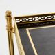 Pair of neoclassical side tables in brass and black leather by Maison Jansen, 1960.