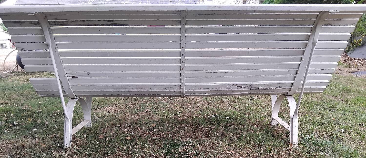 Old garden bench with metal legs and wooden slats